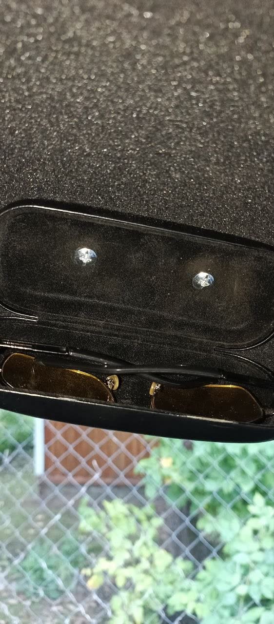 Photo of the finished holder mounted to the headliner with the welded nut-and-washer bolts visible