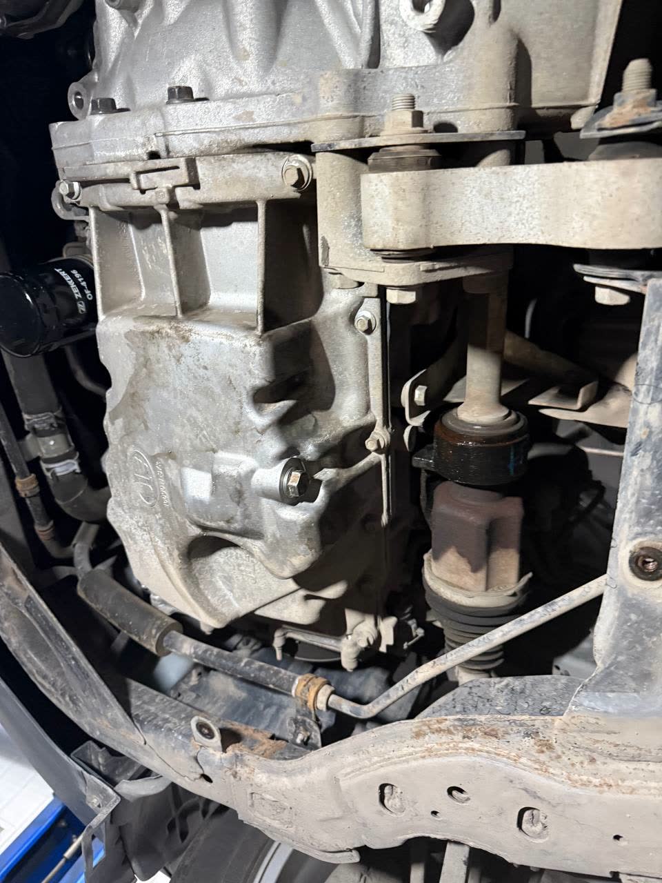 Photo from below of the automatic gearbox casing showing dark oily staining