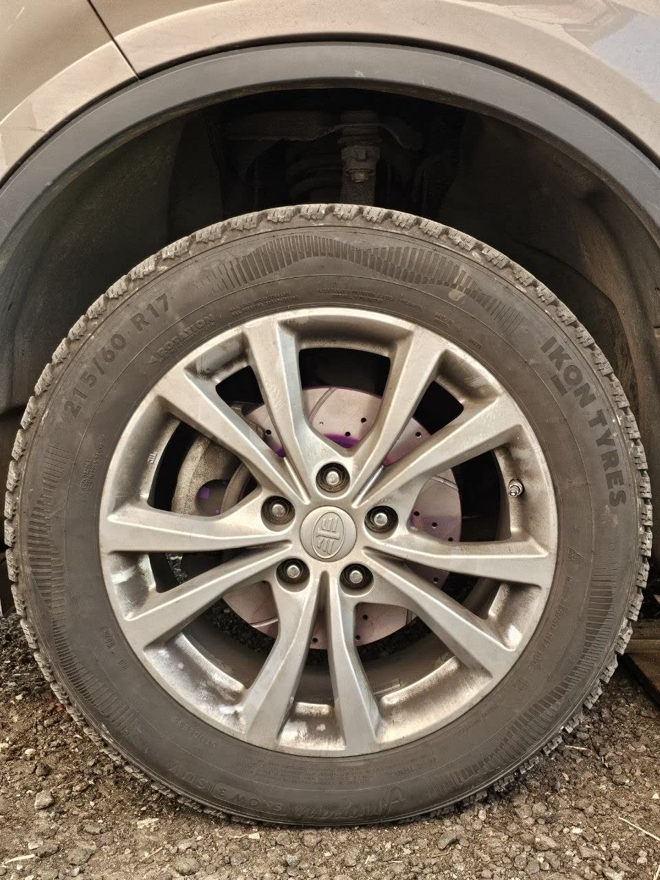 Wheel photo: drilled brake disc painted magenta behind a five-spoke alloy with a FAW centre cap; tyre marked 215/60 R17, IKON Tyres, winter pattern; no part numbers visible