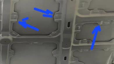 Photo showing hood underside with sealant application points between reinforcer and hood panel