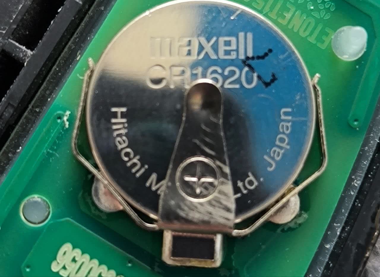Key fob circuit board showing the installed coin cell marked Maxell CR1620 (Hitachi Maxell, Japan)